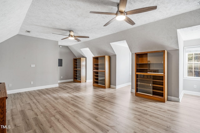 additional living space featuring wood finished floors, a ceiling fan, and vaulted ceiling