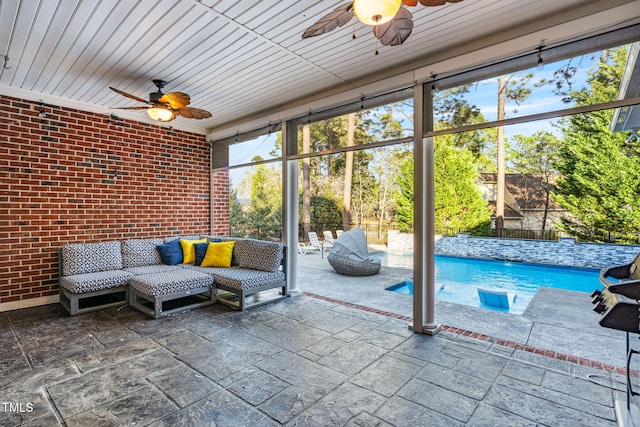 unfurnished sunroom featuring a wealth of natural light and a ceiling fan