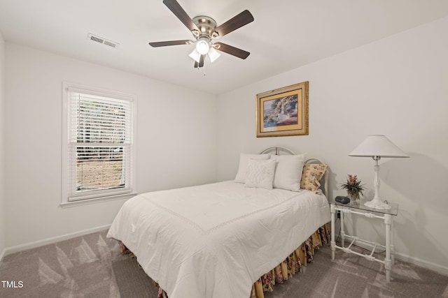 carpeted bedroom featuring visible vents, ceiling fan, and baseboards