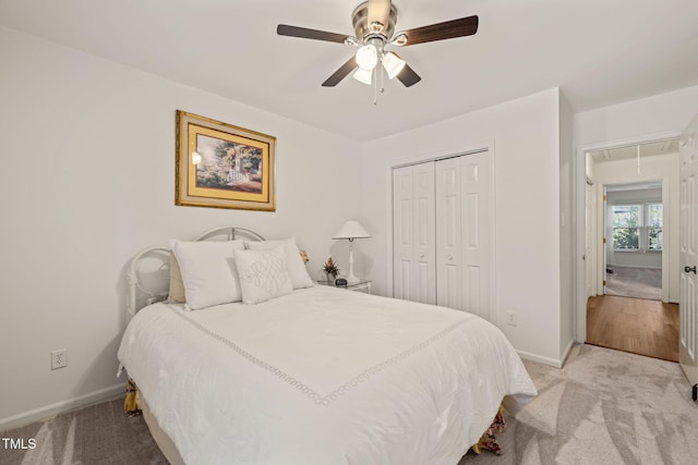 bedroom with attic access, baseboards, a closet, and light carpet