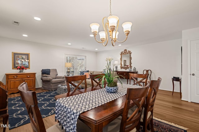 dining room featuring recessed lighting, visible vents, an inviting chandelier, and wood finished floors