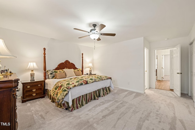 bedroom featuring a ceiling fan, light colored carpet, and baseboards