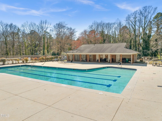 community pool featuring a patio area and fence