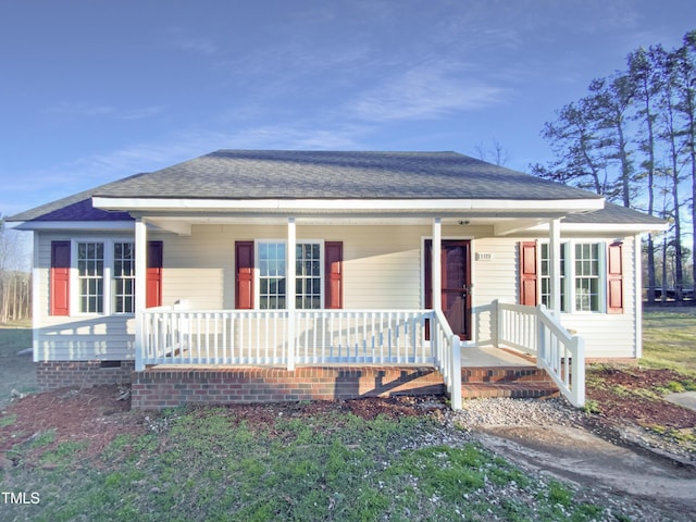 view of front of property with crawl space, a porch, and a shingled roof