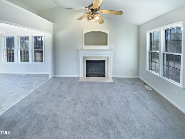 unfurnished living room featuring visible vents, a fireplace, lofted ceiling, and carpet