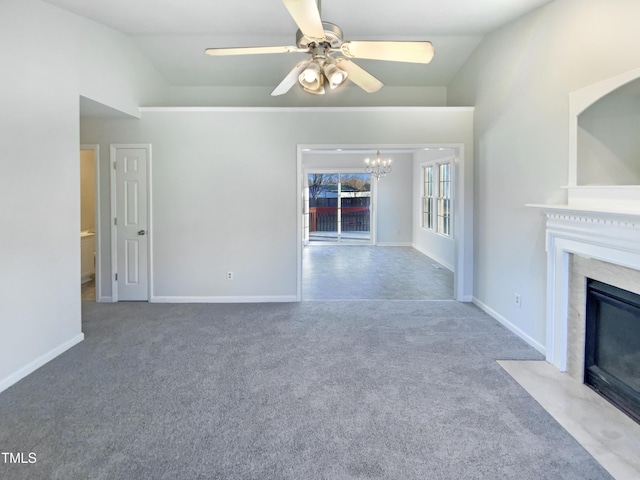 1125 Field Meadows Dr, Zebulon, NC 27597 - unfurnished living room with a high end fireplace, baseboards, carpet, lofted ceiling, and ceiling fan with notable chandelier