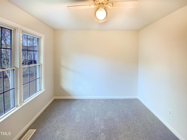 1125 Field Meadows Dr, Zebulon, NC 27597 - carpeted empty room featuring visible vents, a healthy amount of sunlight, baseboards, and ceiling fan