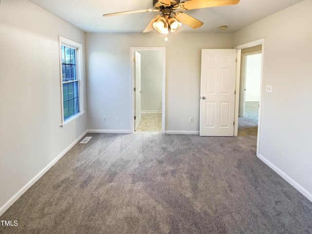 1125 Field Meadows Dr, Zebulon, NC 27597 - unfurnished bedroom with carpet flooring, baseboards, visible vents, and ceiling fan