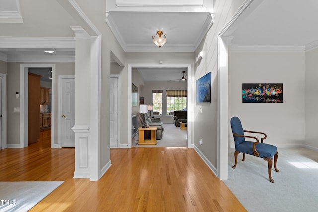 entrance foyer with light wood-type flooring, crown molding, and baseboards