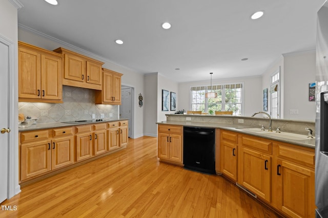 kitchen with light wood finished floors, a sink, ornamental molding, black appliances, and tasteful backsplash