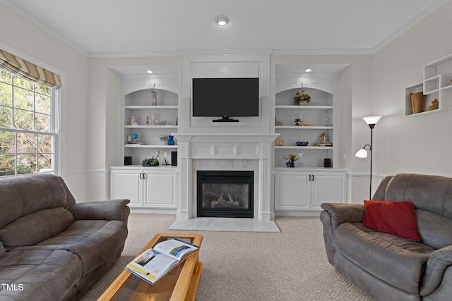 living area featuring built in features, a premium fireplace, light colored carpet, and ornamental molding