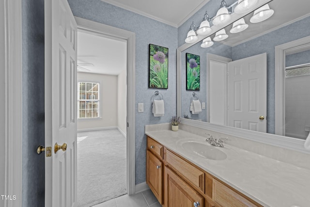 bathroom with tile patterned floors, vanity, crown molding, and baseboards