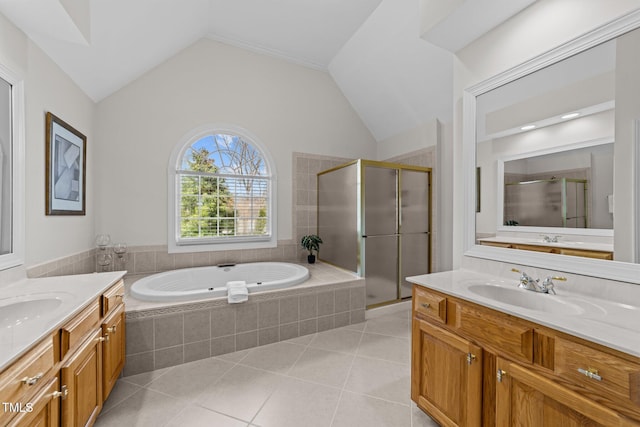 full bathroom featuring tile patterned floors, a stall shower, a sink, a bath, and vaulted ceiling