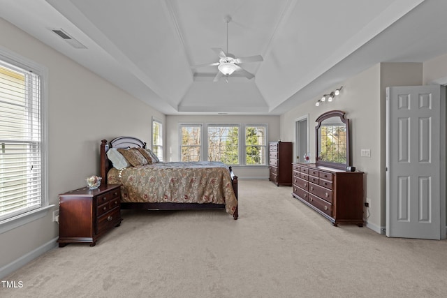 bedroom with visible vents, lofted ceiling, light colored carpet, and baseboards