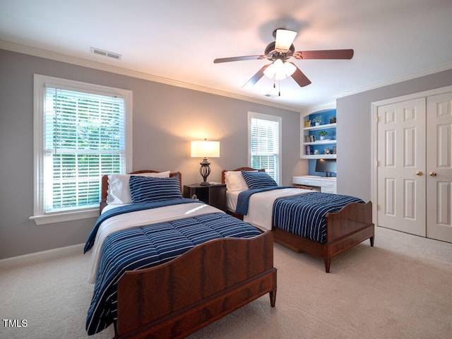 bedroom featuring light colored carpet, multiple windows, ornamental molding, baseboards, and a ceiling fan