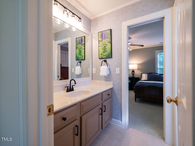 ensuite bathroom featuring ornamental molding, baseboards, tile patterned floors, vanity, and ceiling fan