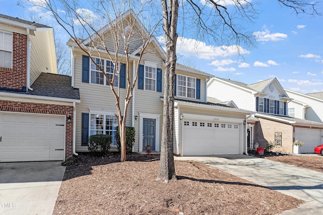 view of front of property featuring brick siding and concrete driveway