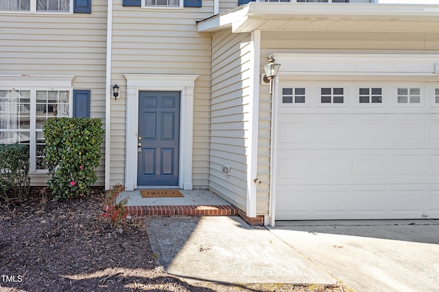 doorway to property with a garage