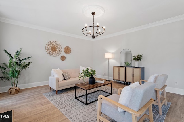 living area with a chandelier, baseboards, light wood-style floors, and ornamental molding