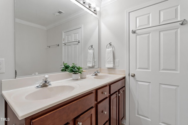 full bathroom featuring double vanity, visible vents, crown molding, and a sink