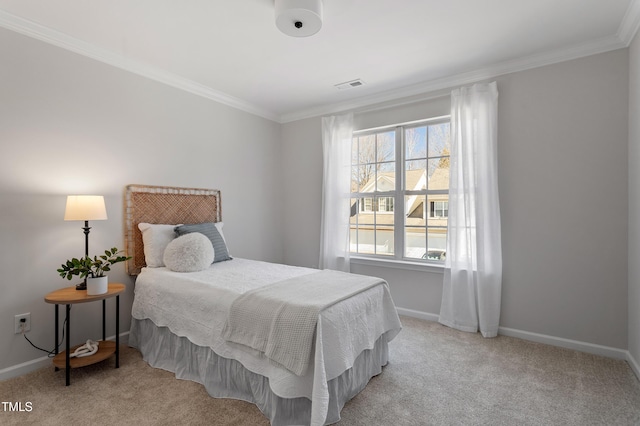 carpeted bedroom with visible vents, baseboards, and ornamental molding