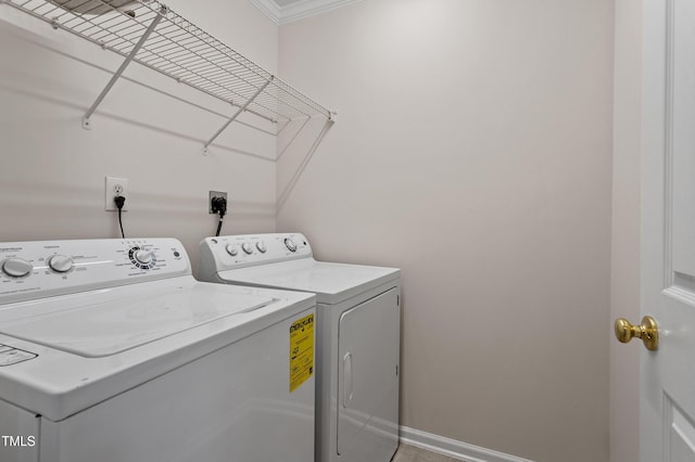 washroom with baseboards, laundry area, and washing machine and clothes dryer