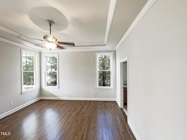 spare room with baseboards, a ceiling fan, dark wood finished floors, and crown molding