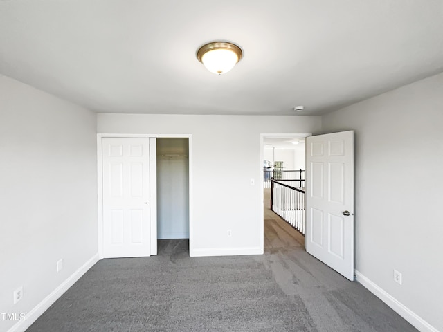 unfurnished bedroom featuring a closet, baseboards, and carpet floors