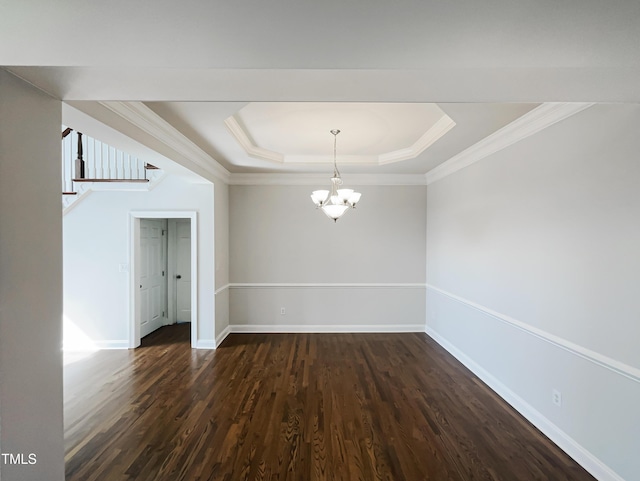 unfurnished dining area featuring baseboards, a tray ceiling, dark wood-style flooring, ornamental molding, and a chandelier