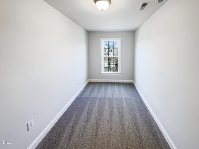 carpeted empty room with baseboards and visible vents