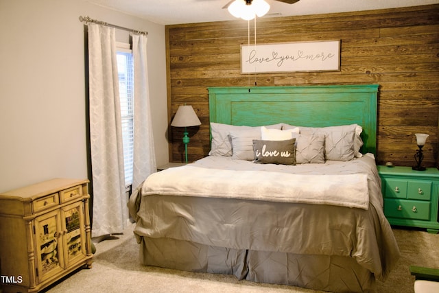 carpeted bedroom featuring wood walls