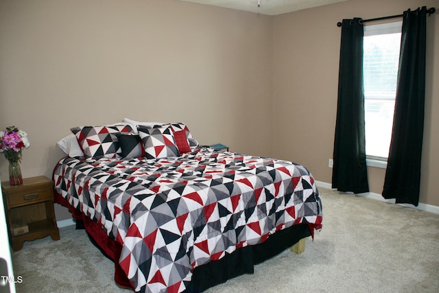 bedroom featuring carpet flooring and baseboards