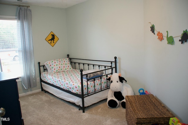 bedroom with multiple windows and carpet floors