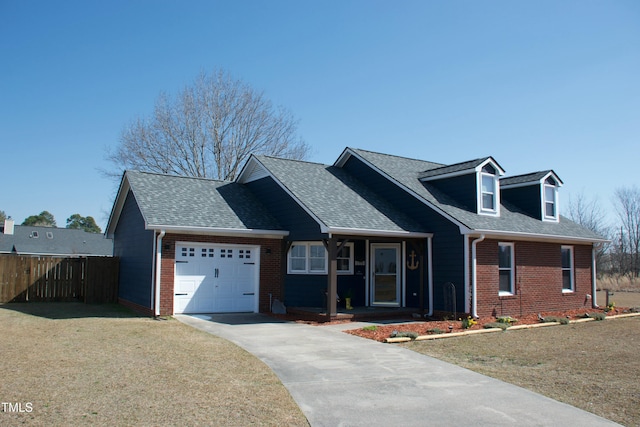 view of front facade with a front lawn, an attached garage, fence, and brick siding