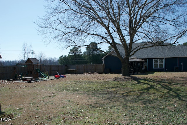 view of yard with a playground and fence