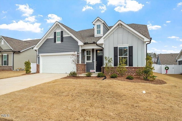 view of front of home with brick siding, board and batten siding, driveway, and fence