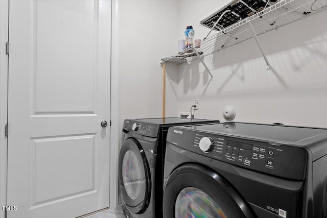 laundry area featuring laundry area and washing machine and clothes dryer