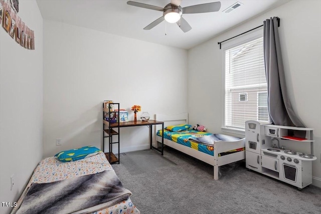 carpeted bedroom with visible vents, baseboards, and ceiling fan