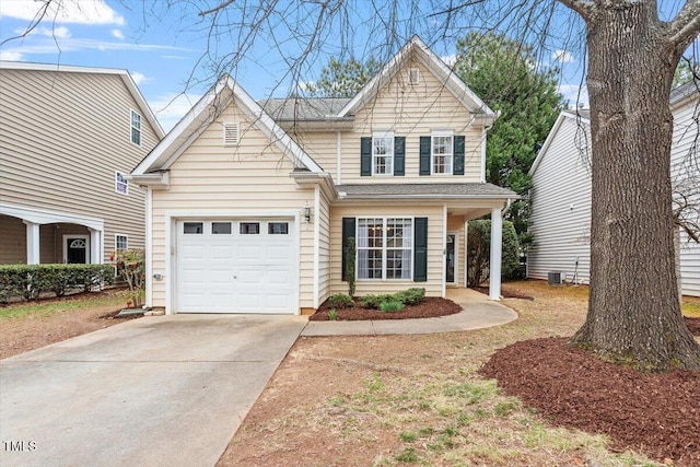 traditional-style home with concrete driveway, an attached garage, and cooling unit