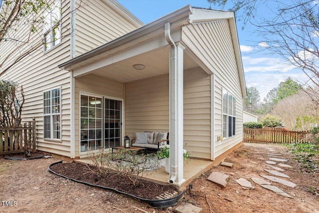 exterior space with outdoor lounge area, a patio, and fence