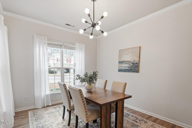 dining space with visible vents, a healthy amount of sunlight, light wood-type flooring, and ornamental molding