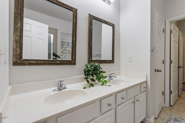 full bathroom featuring double vanity, tile patterned floors, and a sink