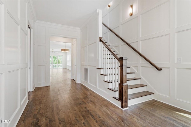 1608 Scales St, Raleigh, NC 27608 - staircase featuring a decorative wall, wood finished floors, and ornamental molding