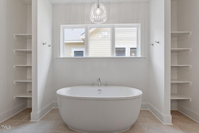 1608 Scales St, Raleigh, NC 27608 - full bathroom featuring a freestanding bath, baseboards, and tile patterned flooring