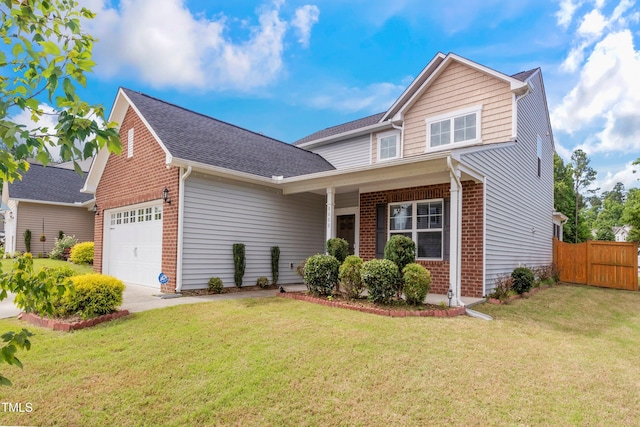 traditional-style home featuring brick siding, an attached garage, a front lawn, and fence