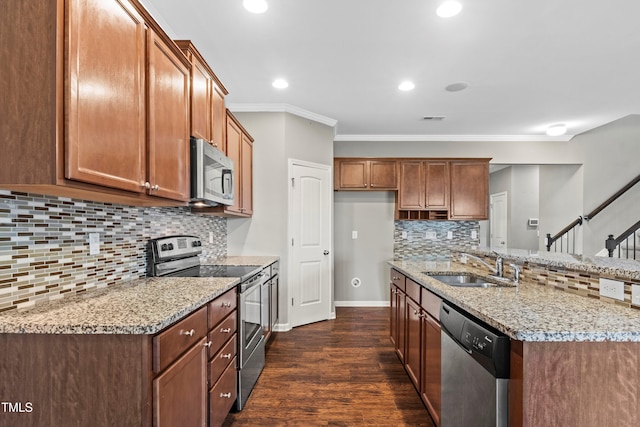 kitchen featuring visible vents, crown molding, baseboards, light stone counters, and stainless steel appliances