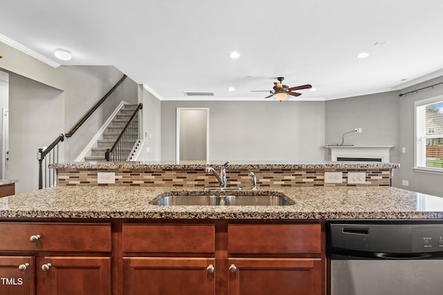 kitchen with a sink, backsplash, dishwasher, and open floor plan