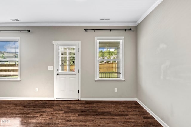 entrance foyer with dark wood finished floors, visible vents, baseboards, and ornamental molding