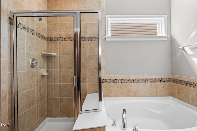 bathroom featuring a shower stall and a garden tub