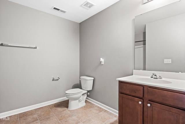 bathroom with visible vents, toilet, vanity, and baseboards